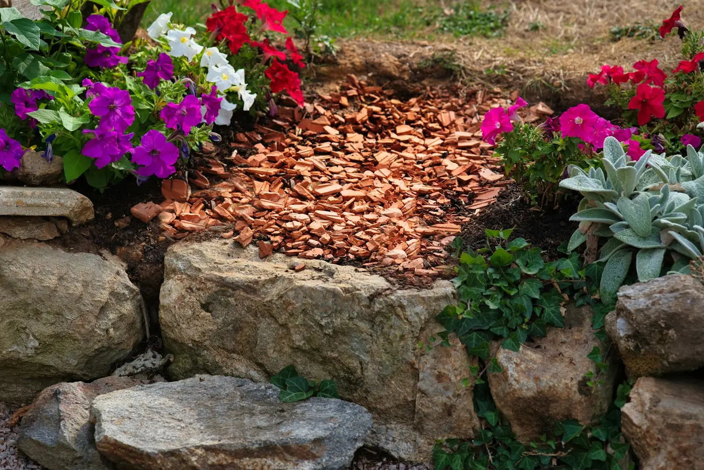 Garden bed with colourful flowers and fresh mulch